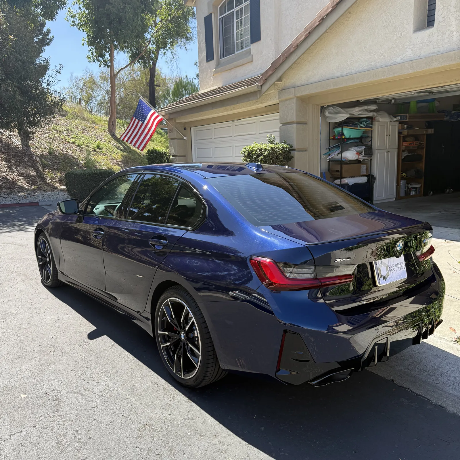 Rear three-quarter view of a blue BMW 3 Series with 20% Nano Ceramic IR tint on the rear windows