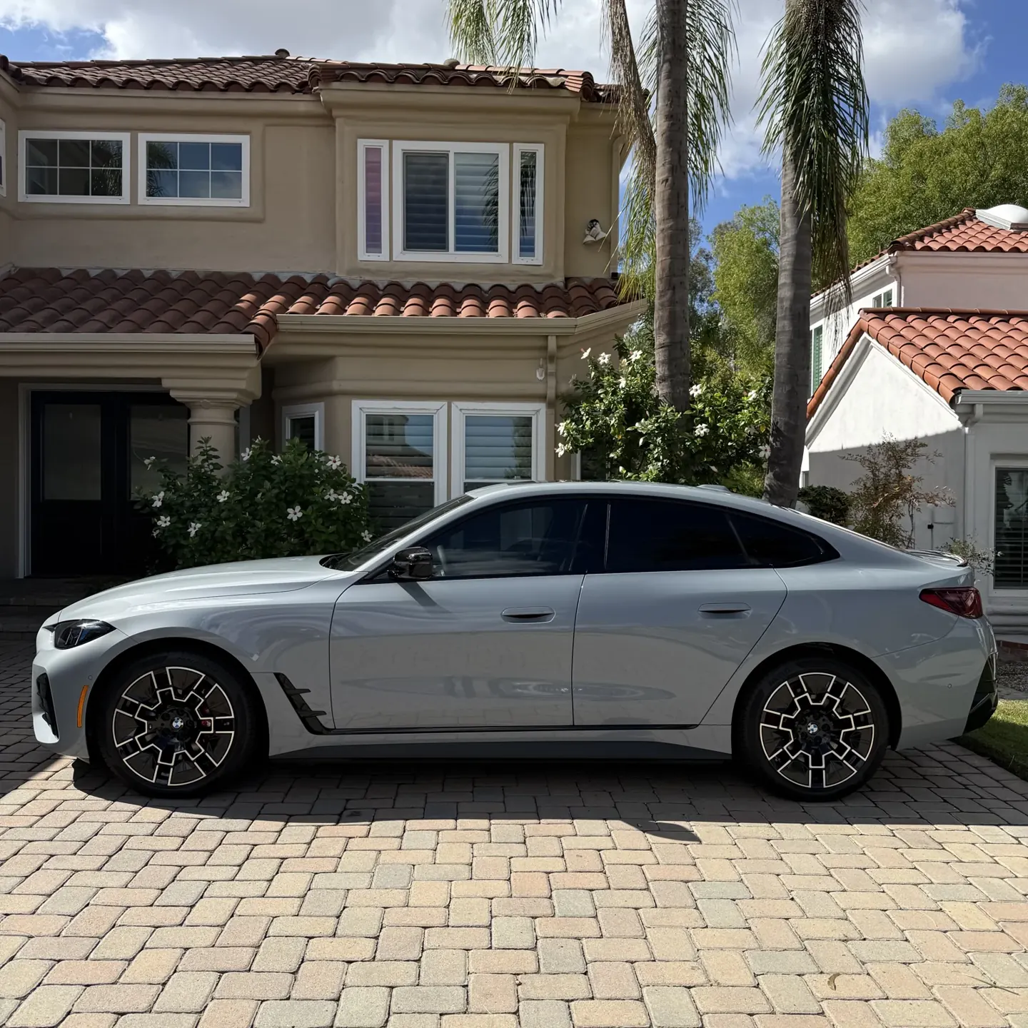 Finished white BMW i4 side view with 35% front and 5% rear-window film