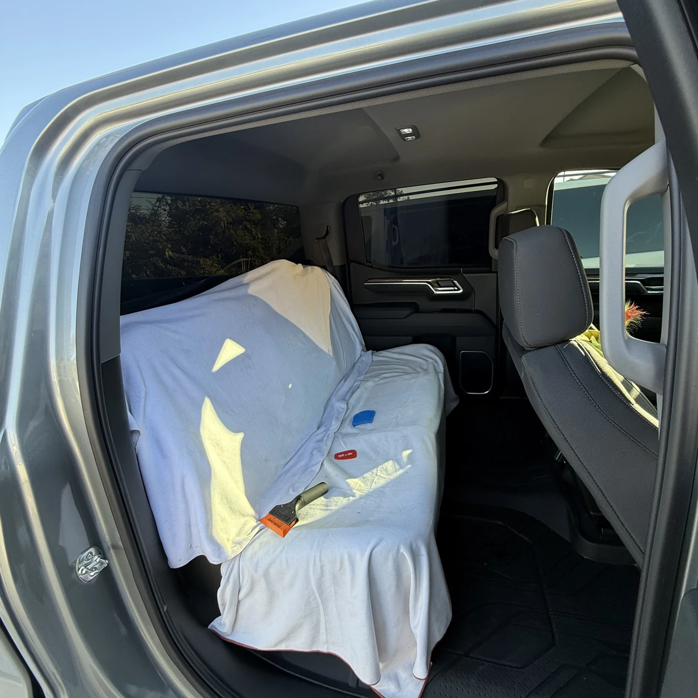 Chevrolet Silverado rear seats protected during rear-window tint installation