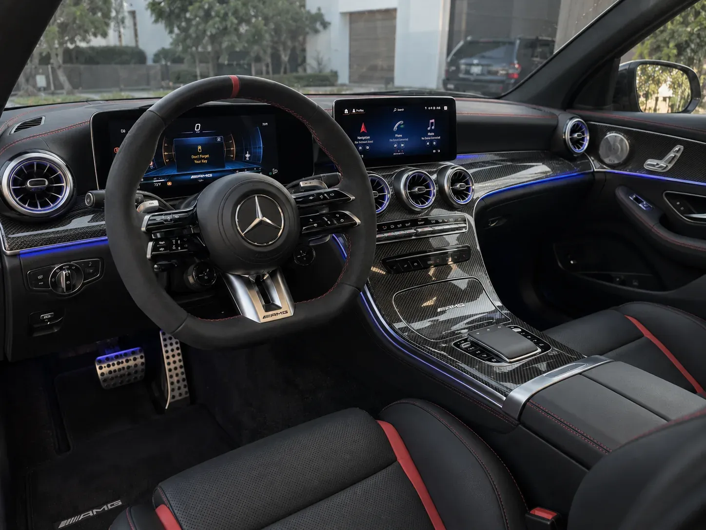 Mercedes-AMG cabin with leather seats, dashboard, steering wheel, and carbon-fiber interior trim.