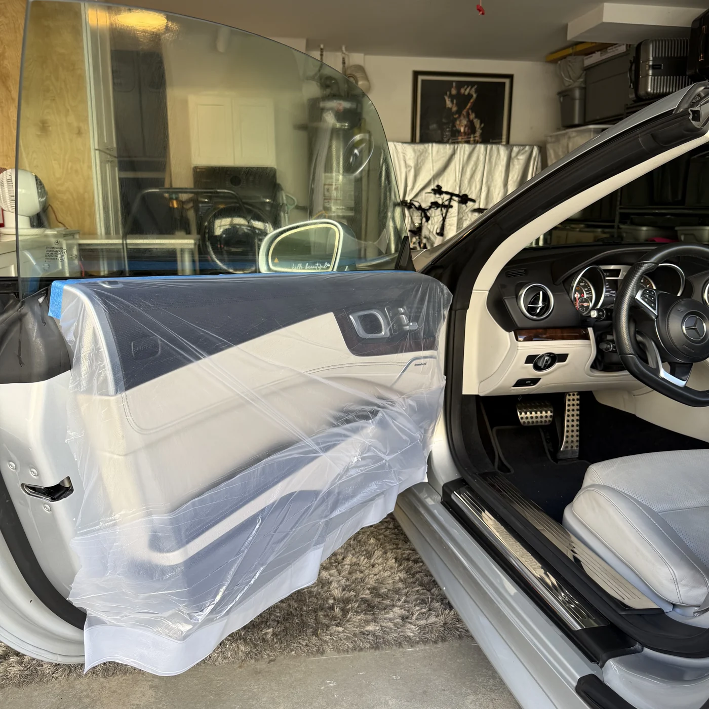 Protective sheeting covering the Mercedes-Benz SL550 door panels during window tint installation