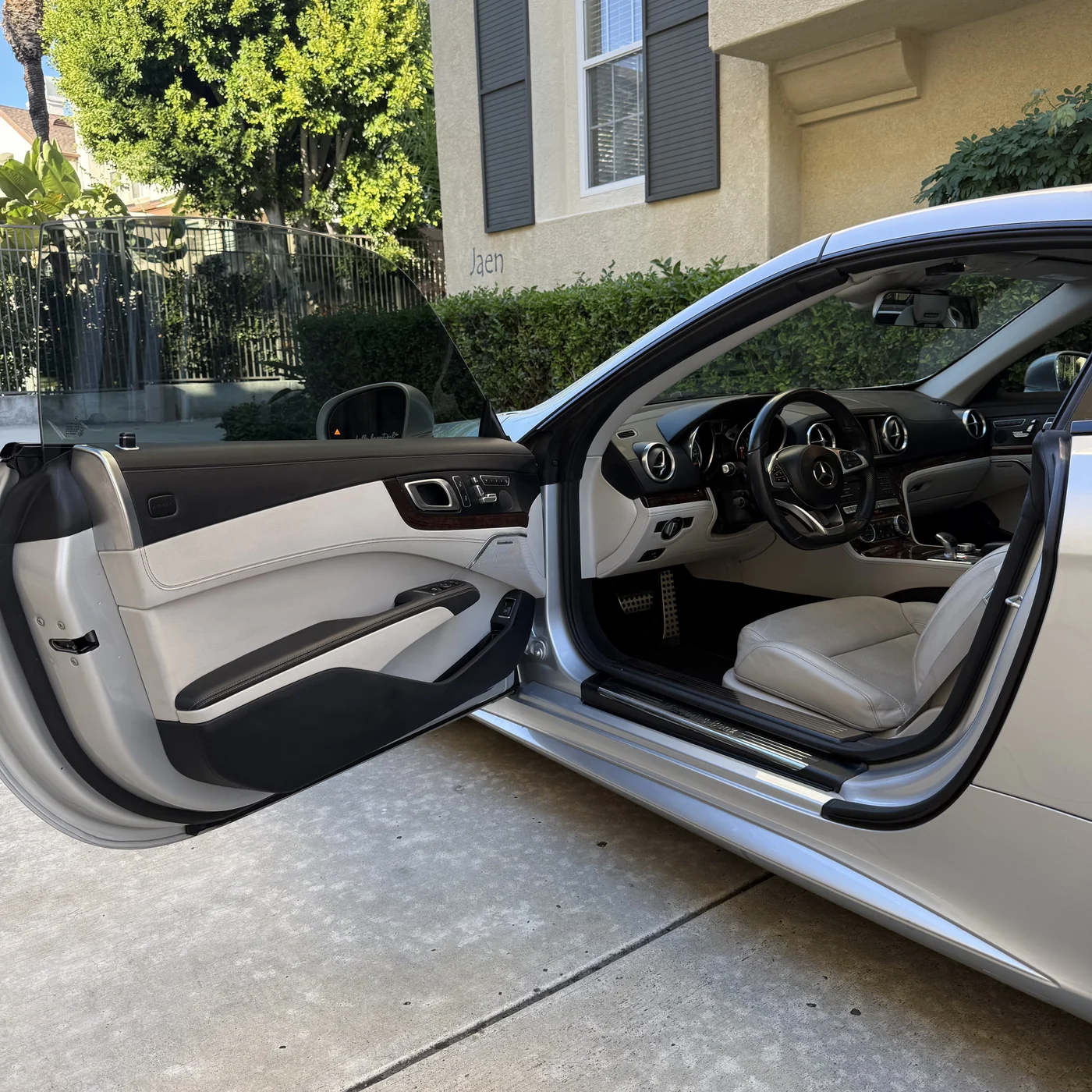 Finished Mercedes-Benz SL550 door glass and cream interior after window tint installation