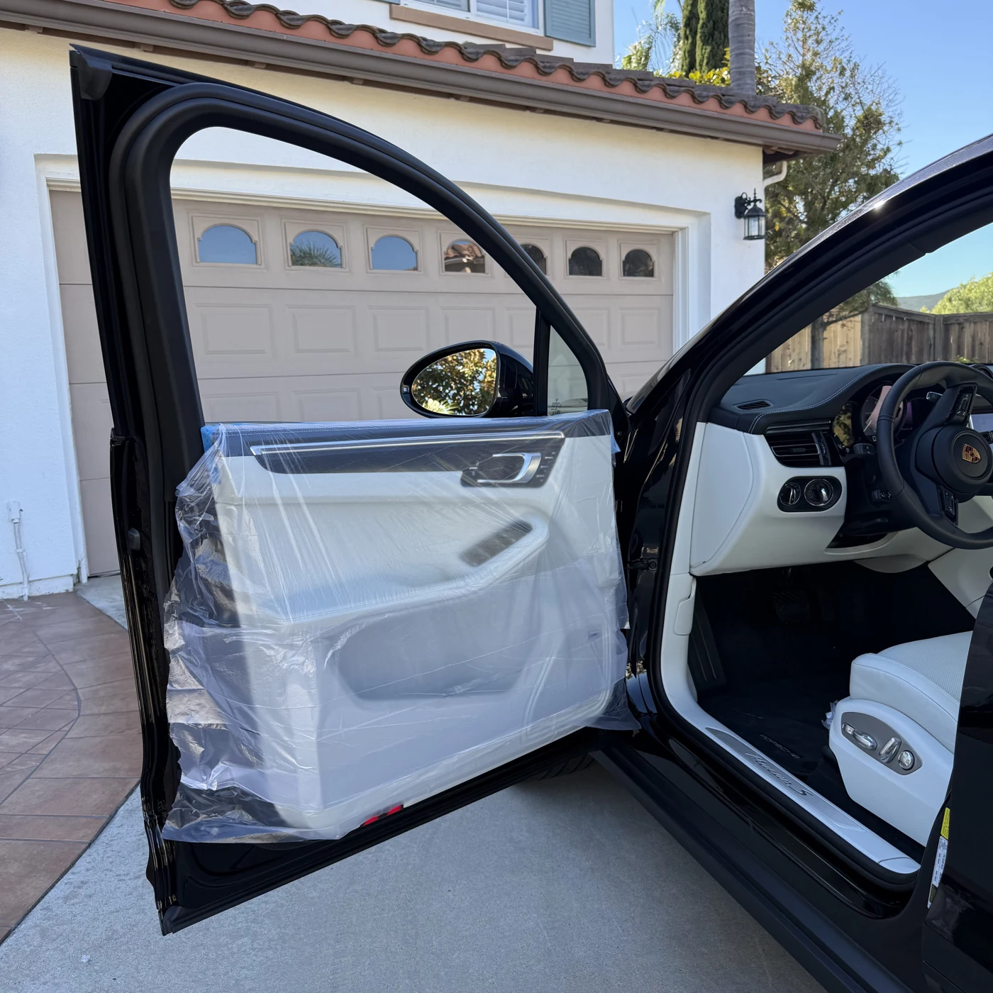 Porsche Macan door panels covered with protective sheeting before window tint installation